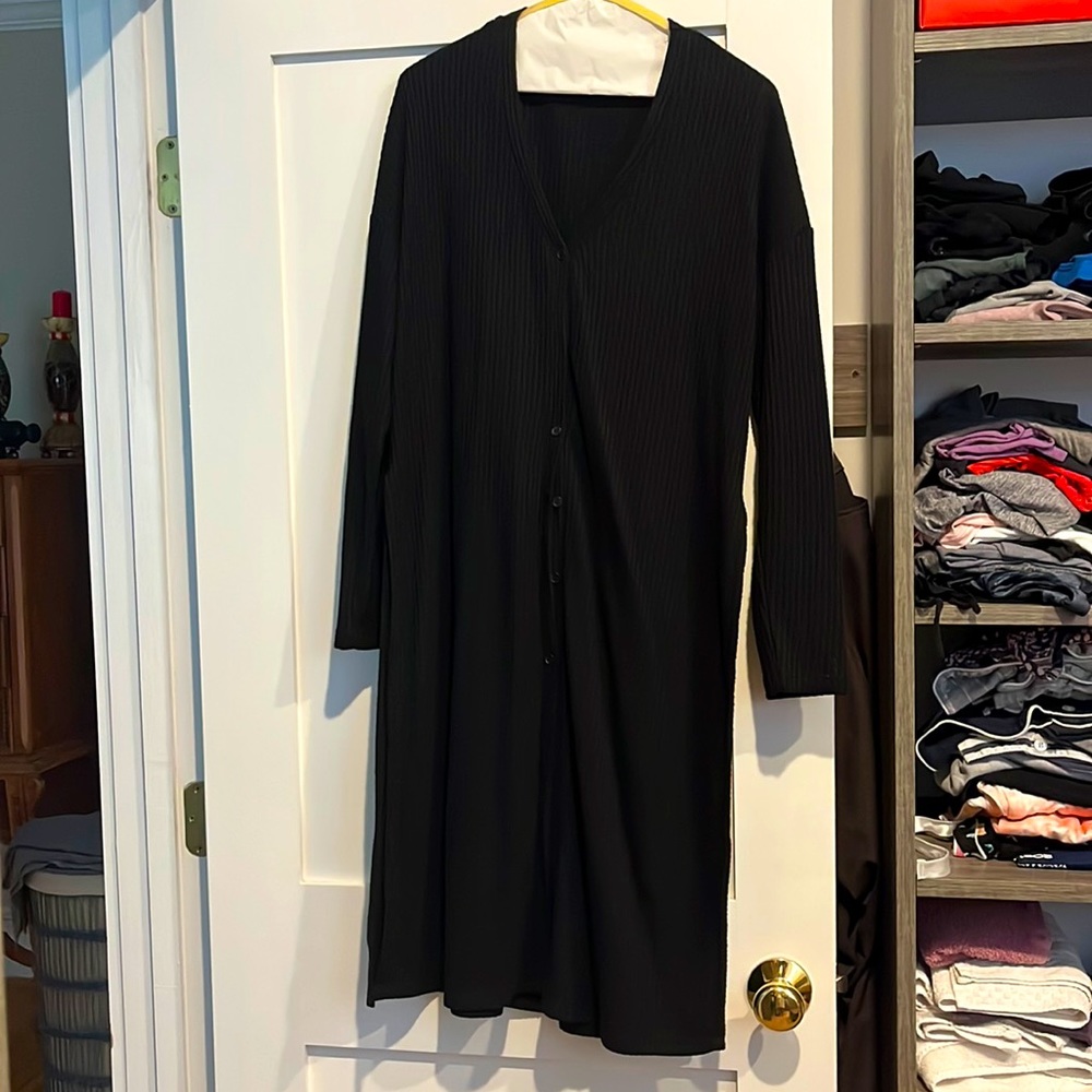 Long-sleeved waffle knit cardigan too with buttons and slits along the side.